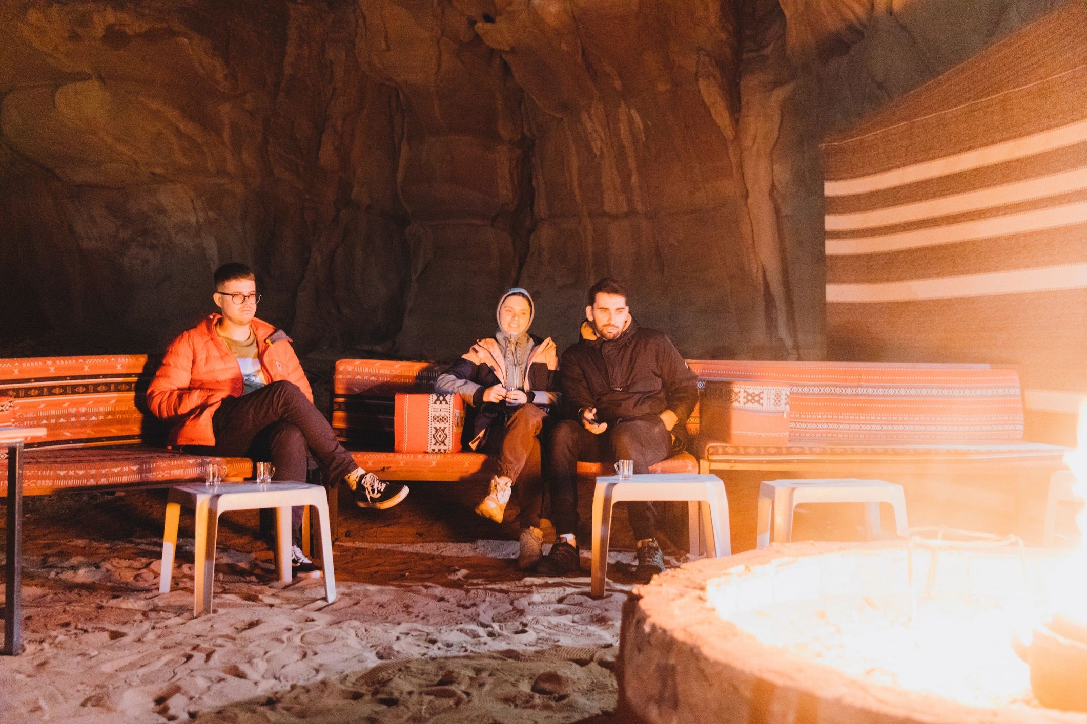 Friends enjoying night at the bedouin camp by campsite in Wadi Rum desert